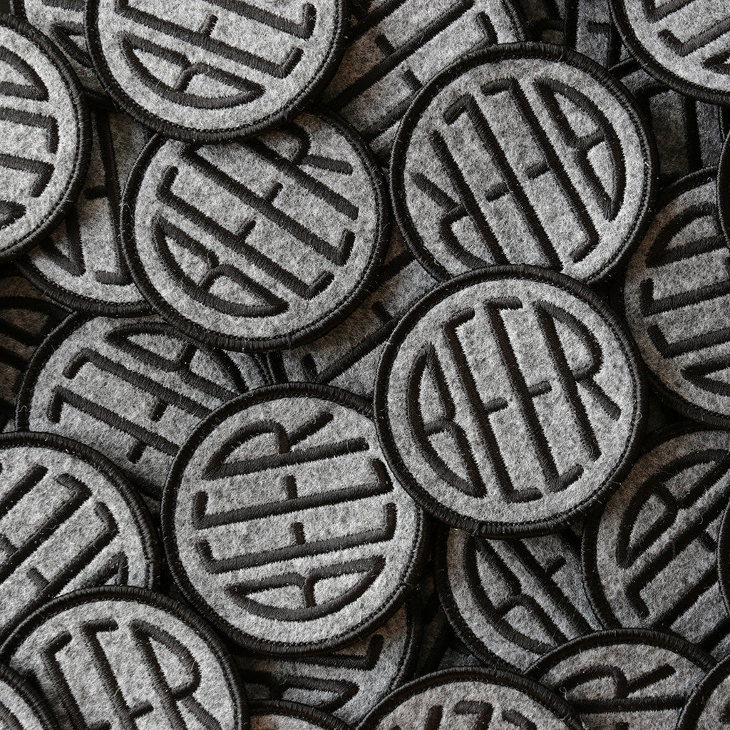 Embroidered BEER patch with black embroidery thread on heather grey felt