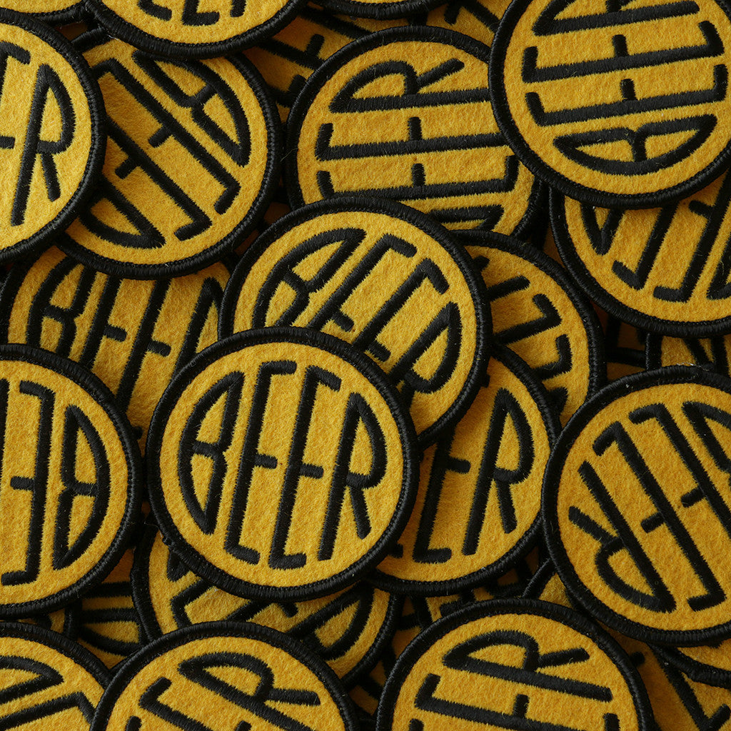 Embroidered BEER patch with black embroidery thread on yellow felt