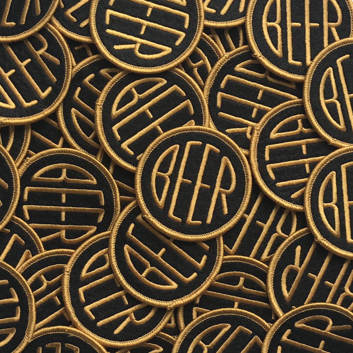 Embroidered BEER patch with gold embroidery thread on black felt