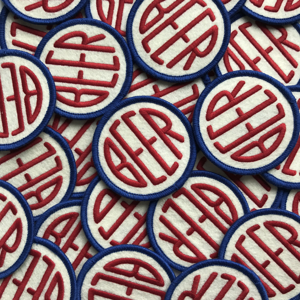 Embroidered BEER patch with red and blue embroidery on off-white felt