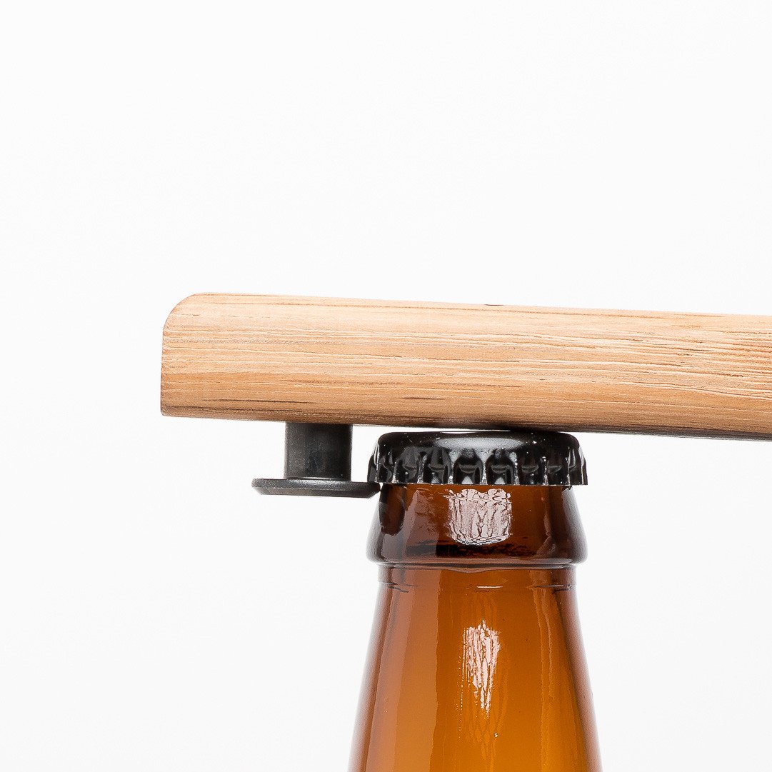 Quercus Alba Reclaimed Wood Bottle Opener on bottle cap ready to open