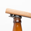 Quercus Alba Reclaimed Wood Bottle Opener lifting cap from bottle pshhht
