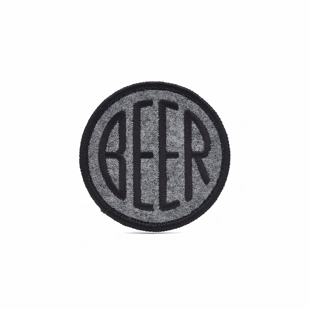 Embroidered BEER patch with black embroidery thread on heather grey felt